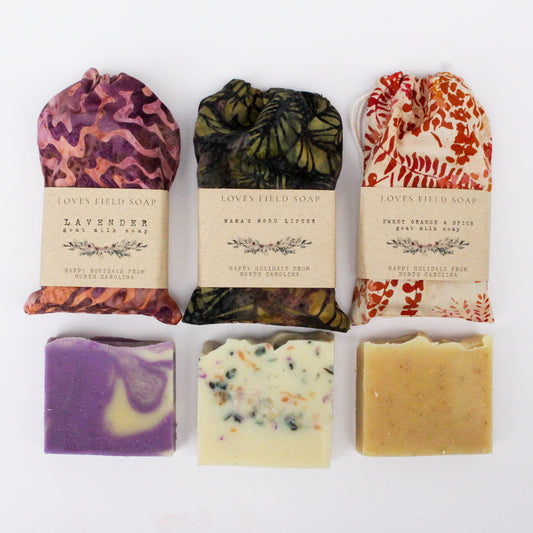 Assorted soaps with decorative packaging on a white background