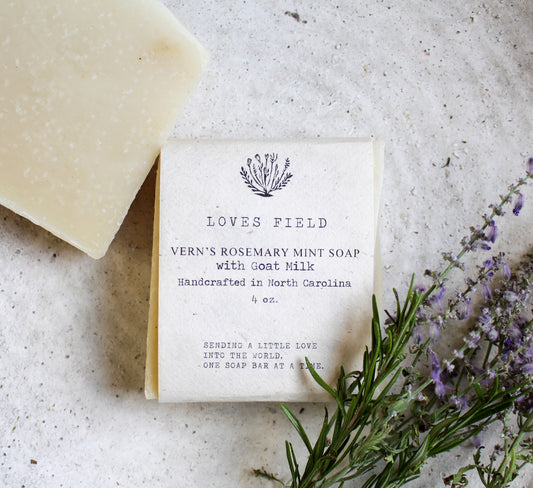 a bar of rosemary mint soap on a white textured background